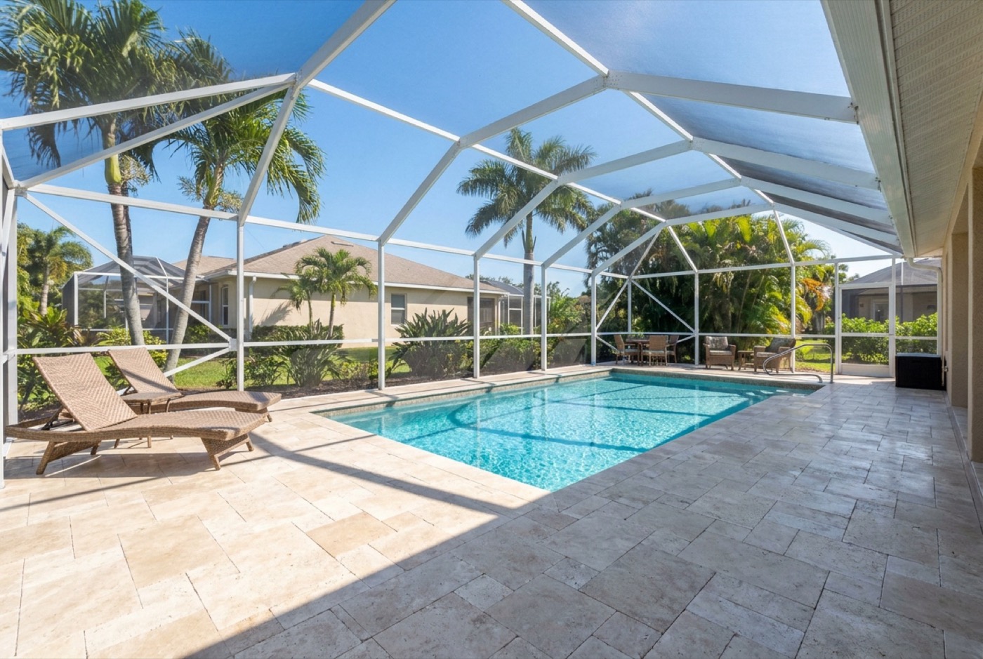 Travertine pool deck cleaned of mold and algae at a Naples home